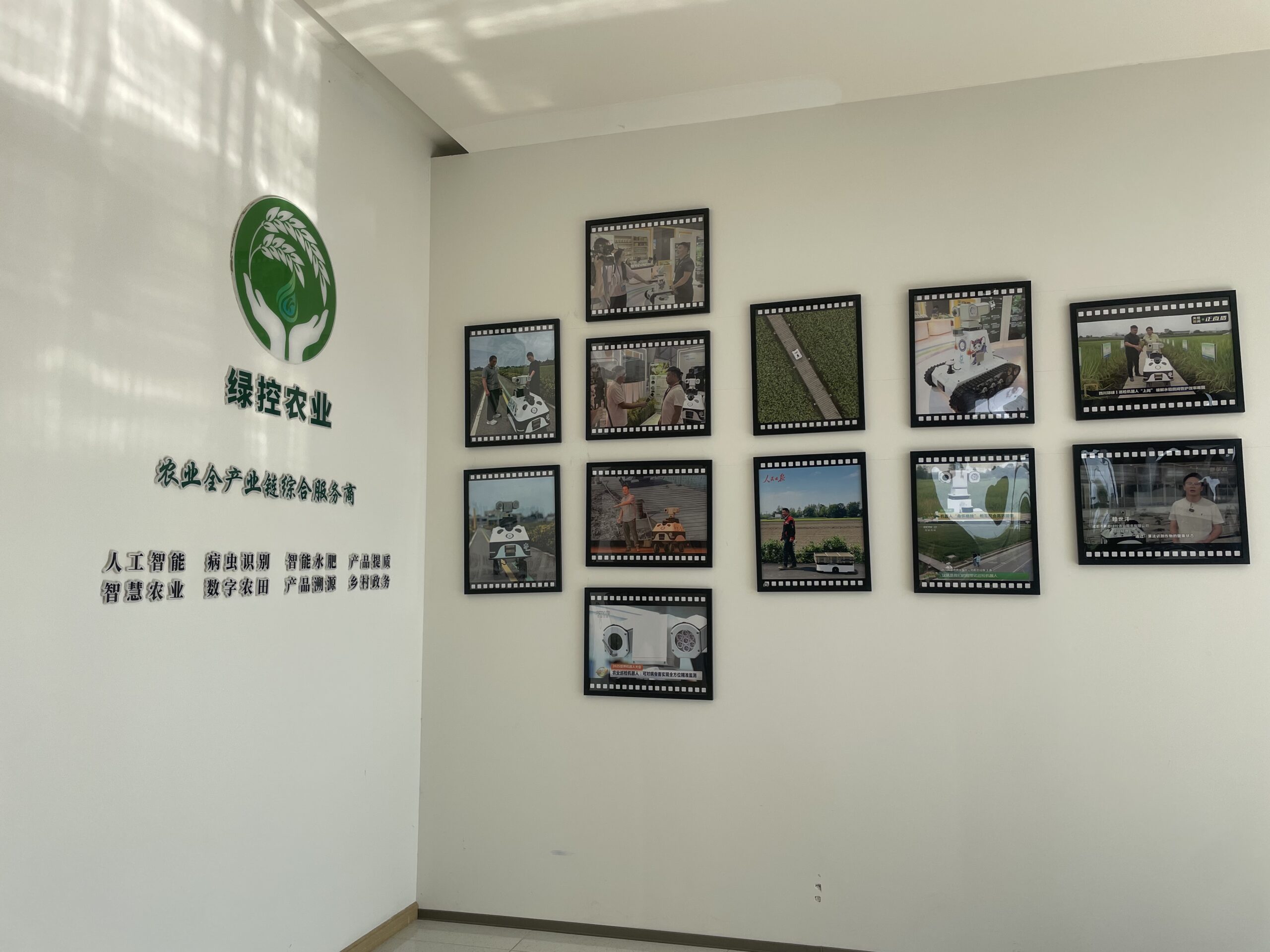 Green Control Robotics office wall with media reports and autonomous mobile robot chassis exhibition photos
