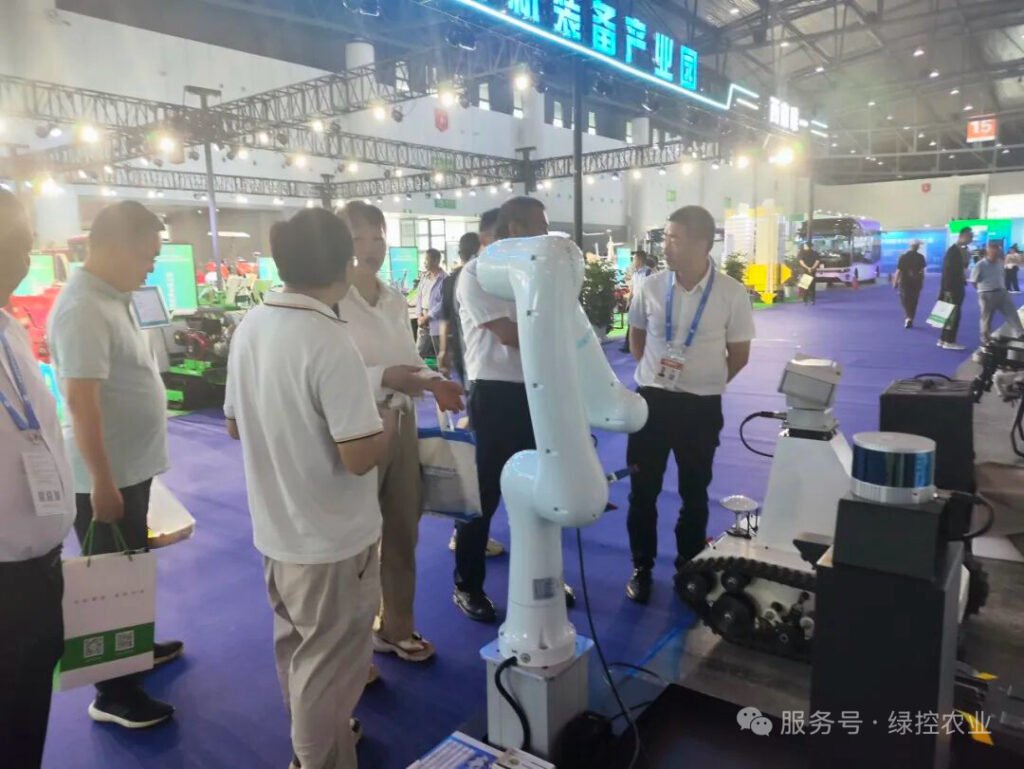 Clients discussing intelligent robotic arm integration at GC Robotics WCIF 2025 booth