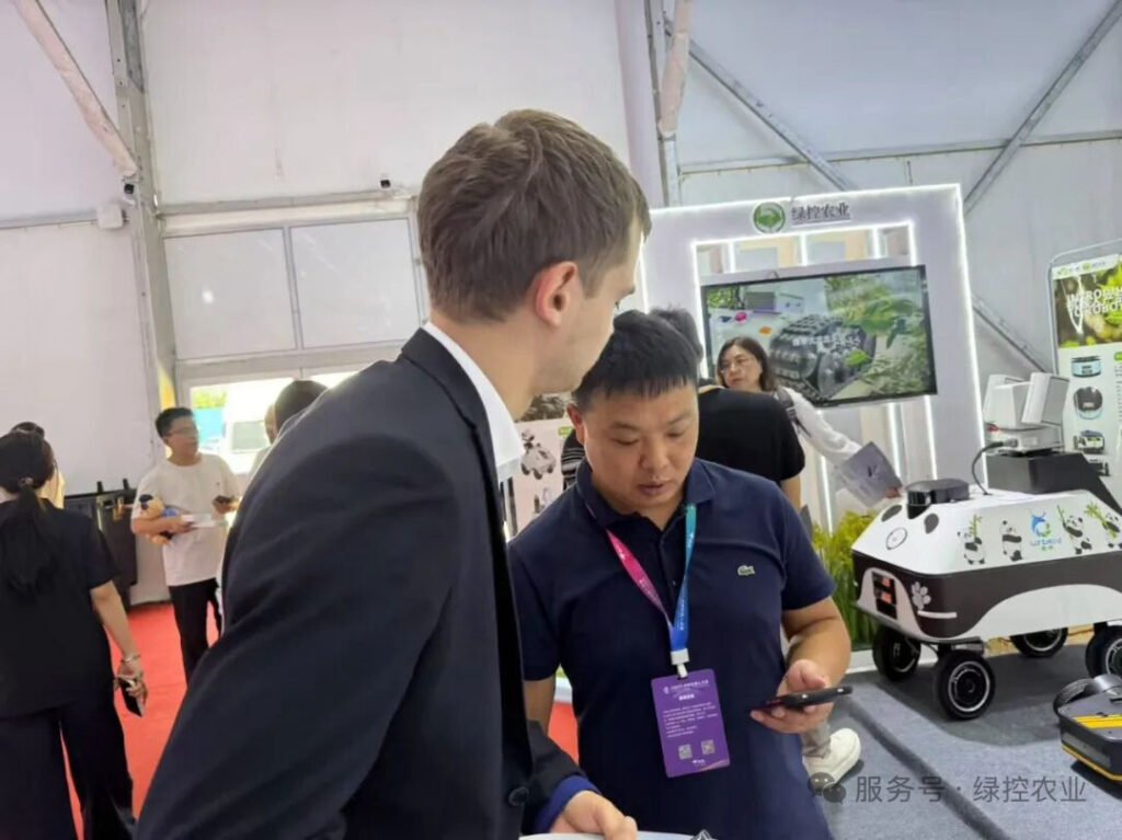 International buyer consulting with GC Robotics representative at WRC 2025 booth