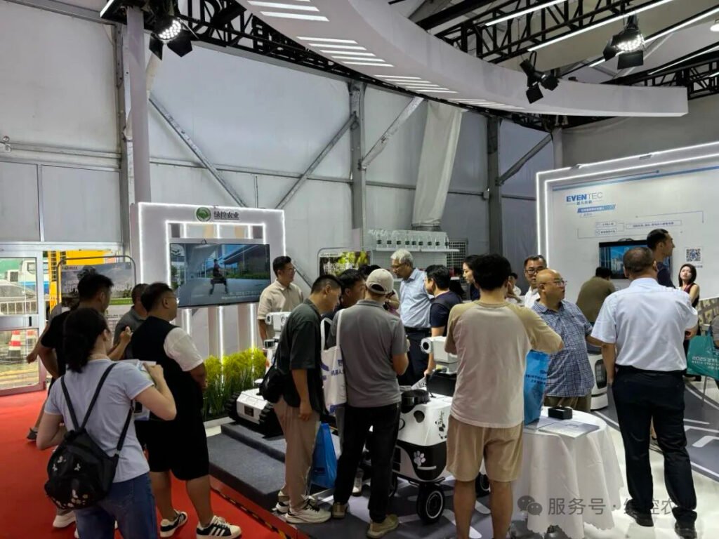 Visitors exploring a robotics booth at WRC 2025