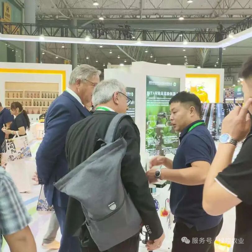 International visitors exploring GC Robotics mobile robot platforms at an exhibition