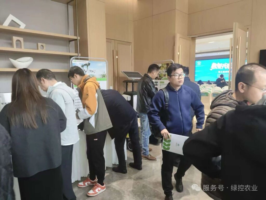 Group of visitors discussing GC Robotics agricultural inspection robots at the exhibition booth