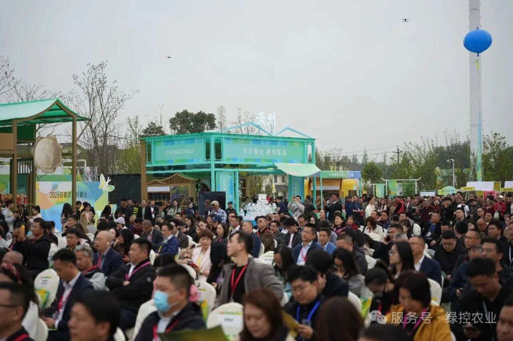 Large crowd of attendees walking around exhibition stalls at Chengdu First Village Fair