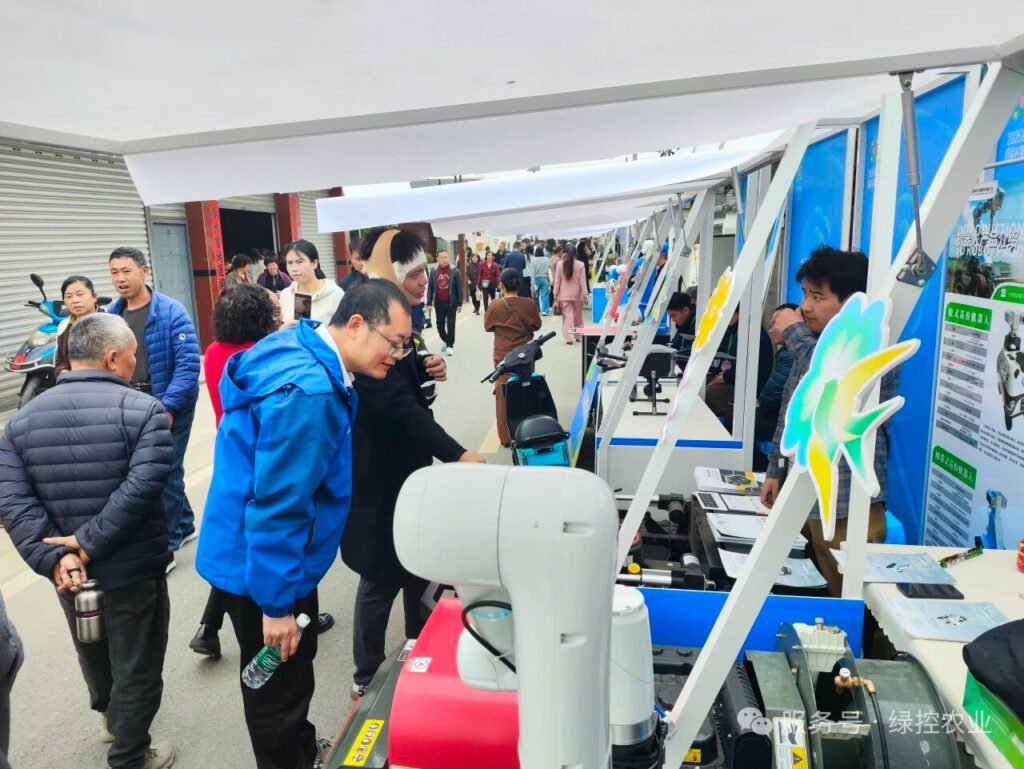 GC Robotics agricultural robot display booth with visitors at Chengdu First Village Fair