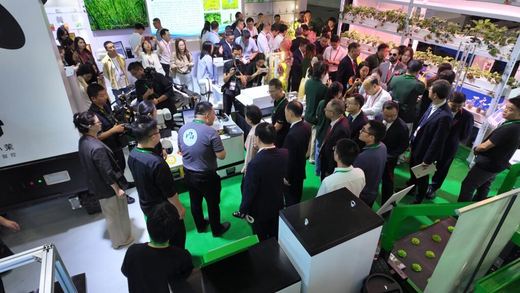 GC Robotics staff introducing a ROS-based mobile robot chassis/platform and inspection robots to government officials at the 2026 Chengdu Agriculture Expo.