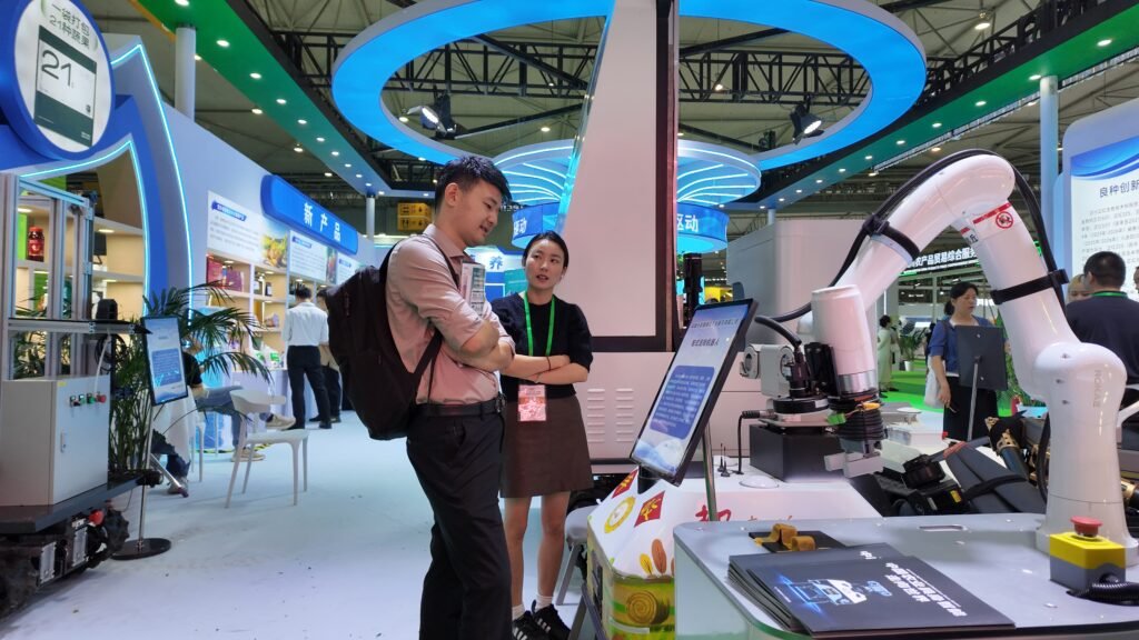 GC Robotics team explaining its wheeled inspection robot and autonomous navigation capabilities to interested visitors at the Chengdu Expo.