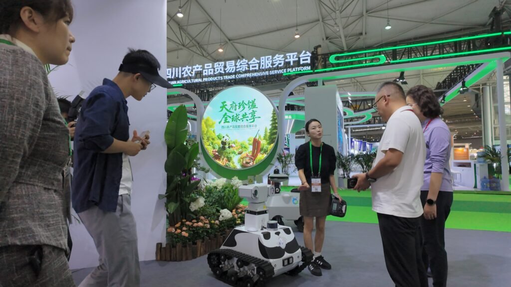 GC Robotics team explaining its tracked inspection robot and autonomous navigation capabilities to interested visitors at the 12th Chengdu Expo.