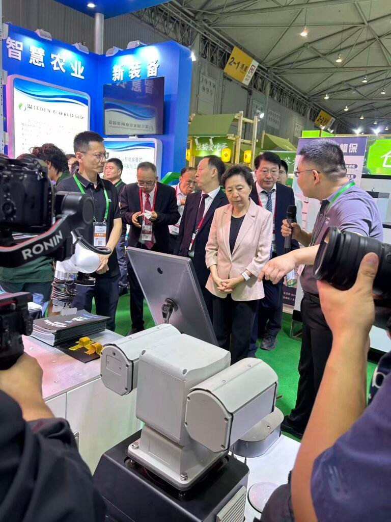 GC Robotics staff presenting a wheeled inspection robot to government officials during the 2026 Chengdu Expo.
