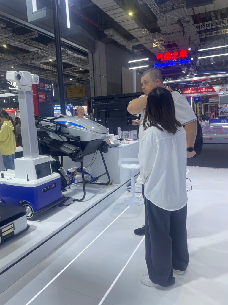 GC Robotics team introducing a lifting wheeled robot chassis to visitors at CIIF 2026 in Shanghai.